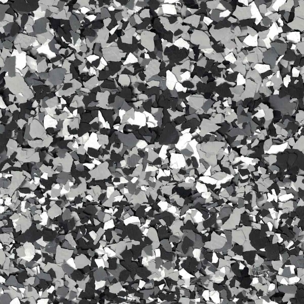 This image shows an abstract pattern of scattered, irregular shapes in various shades of gray, resembling a textured collage or a digital mosaic.