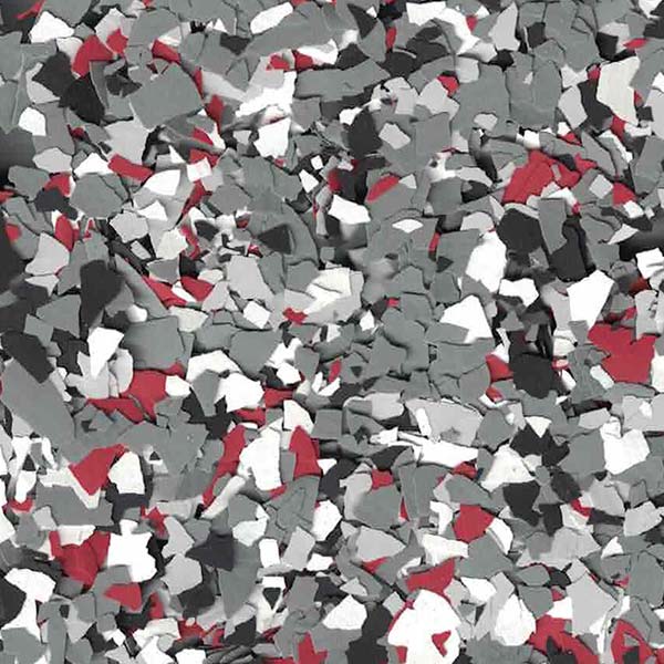 The image shows an assortment of irregularly shaped particles in shades of gray, white, and red, densely packed to form a textured surface.