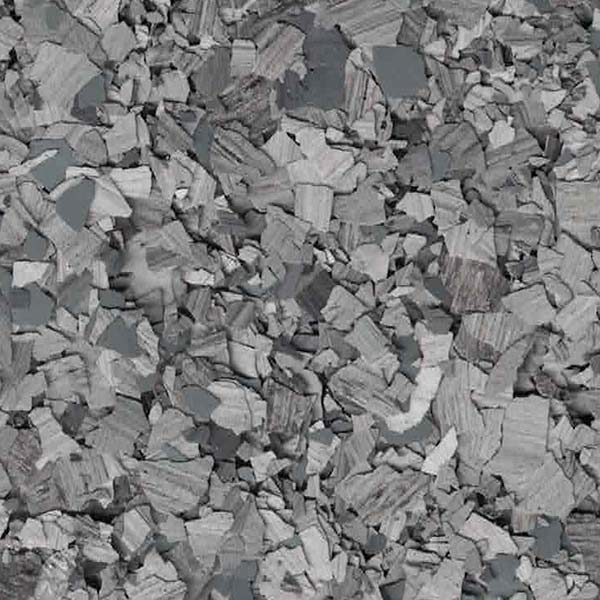 The image shows a large pile of broken, flat grey stones, densely packed together, creating a textured surface of rocks with sharp edges.