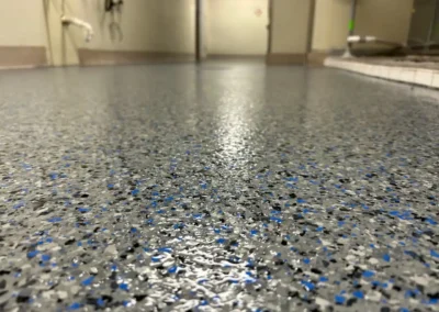 A Grey and Blue floor coating done professionally by Higgins Coatings
